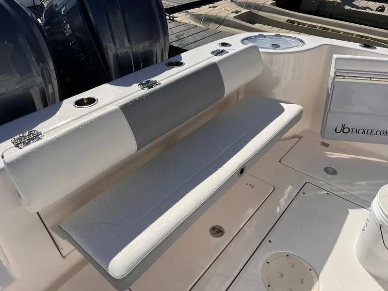 Slide: The Image of 2023 Robalo R302 Center Console boat with cushioned seating and rod holders. - 9