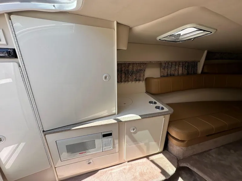 Slide: The Image of Interior of 2000 Formula 330 SS boat with kitchenette and seating area. - 26