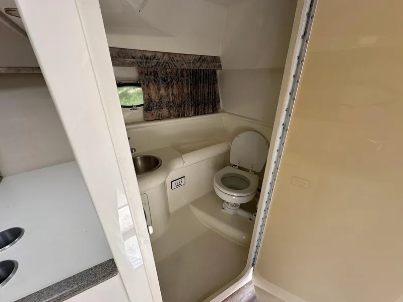 Slide: The Image of Interior of a 2000 Formula 330 SS boat bathroom with sink and toilet. - 33