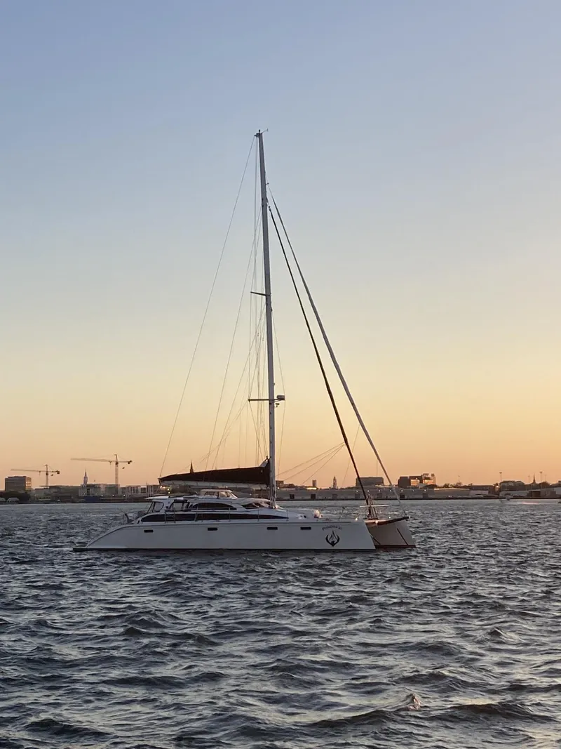 Slide: The Image of 2010 Broadblue 435 catamaran sailing at sunset on calm waters. - 13