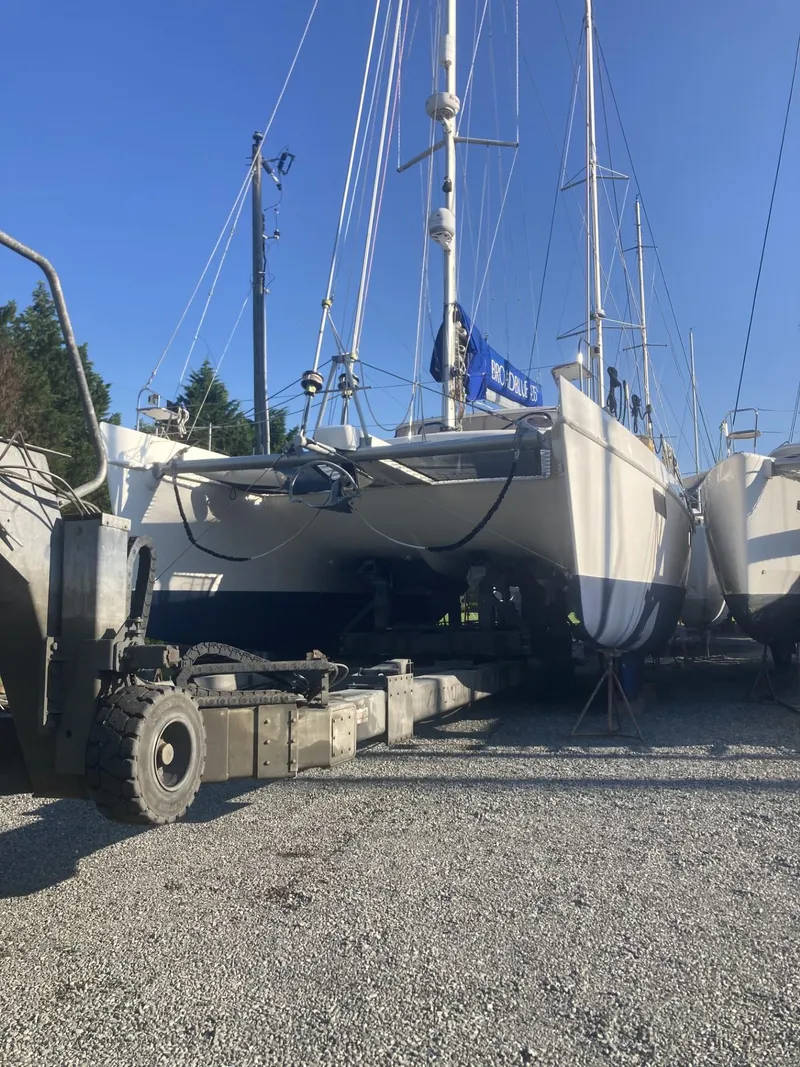 Slide: The Image of Broadblue 435 catamaran from 2010 on dry dock, surrounded by other boats. - 15