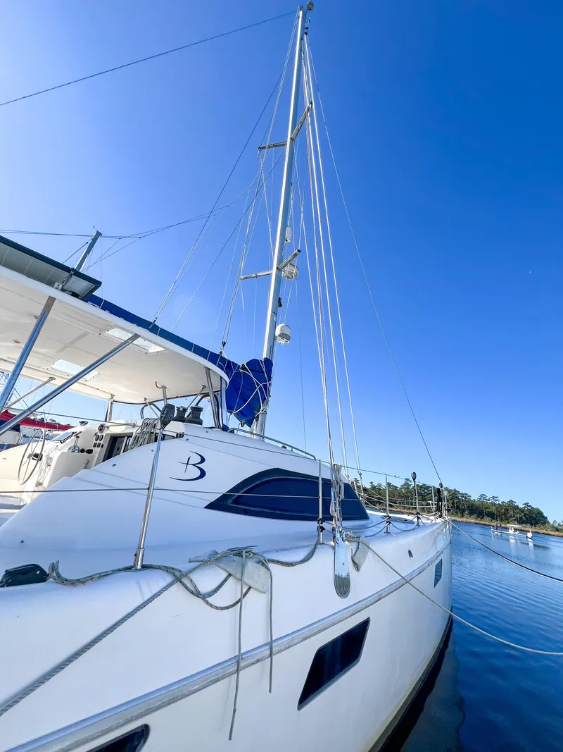 Slide: The Image of 2010 Broadblue 435 catamaran docked on calm water under clear blue sky. - 17