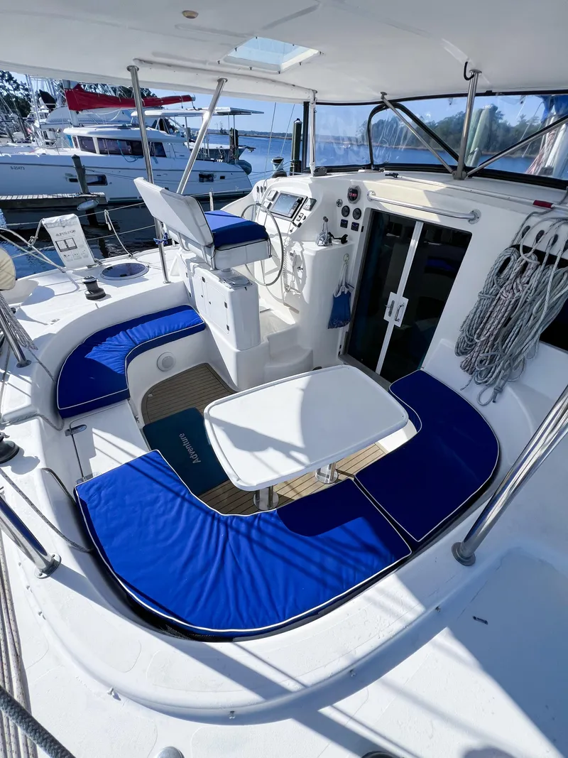 Slide: The Image of 2010 Broadblue 435 yacht cockpit with blue seating, steering wheel, and navigation equipment. - 23