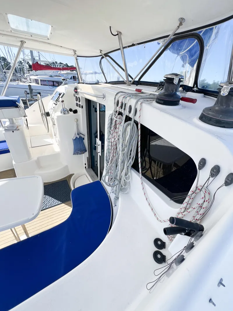 Slide: The Image of Broadblue 435 catamaran cockpit, 2010 model, featuring ropes and winches, with blue seating. - 24