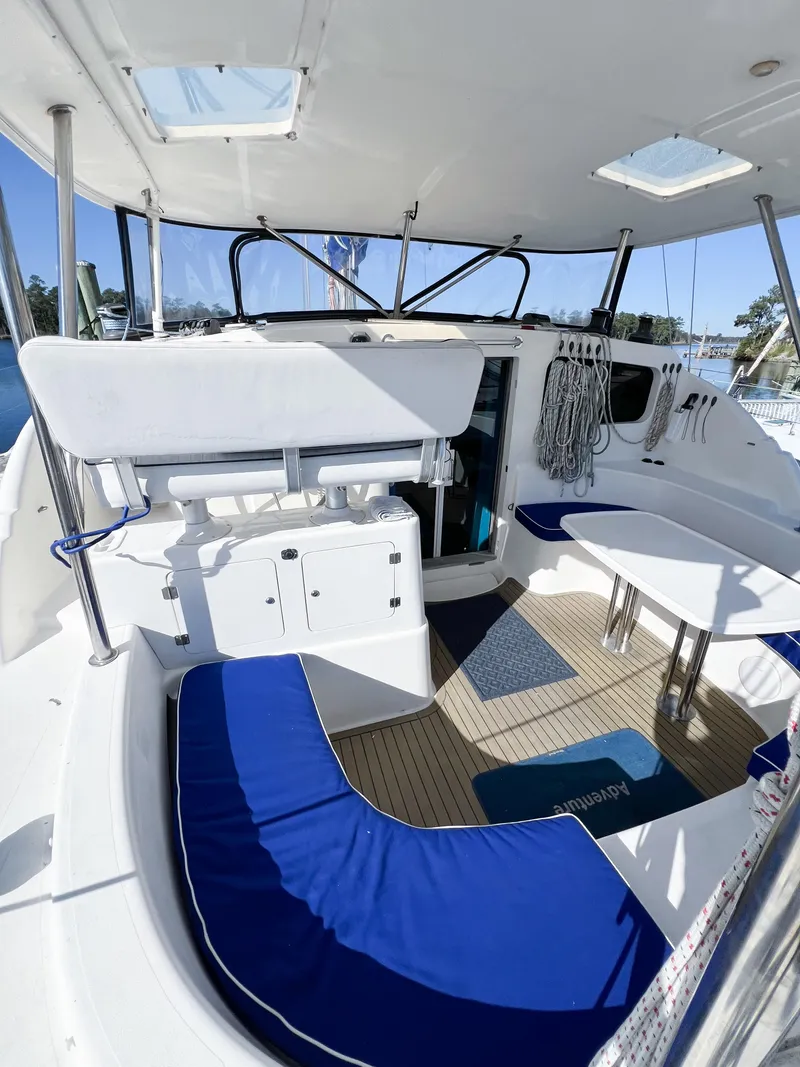 Slide: The Image of 2010 Broadblue 435 catamaran cockpit with blue seating, white table, and nautical decor. - 25