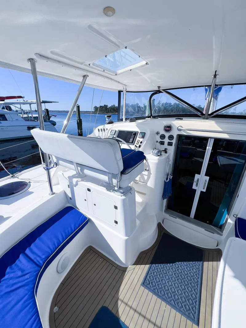 Slide: The Image of Broadblue 435 catamaran cockpit, 2010 model, featuring blue seating and modern navigation controls. - 27