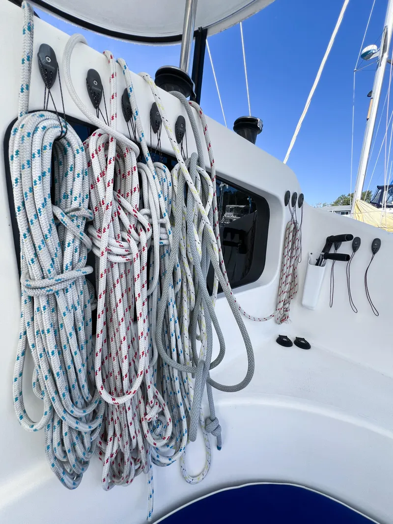 Slide: The Image of Sailing ropes on a 2010 Broadblue 435 catamaran, neatly organized against a clear blue sky. - 33