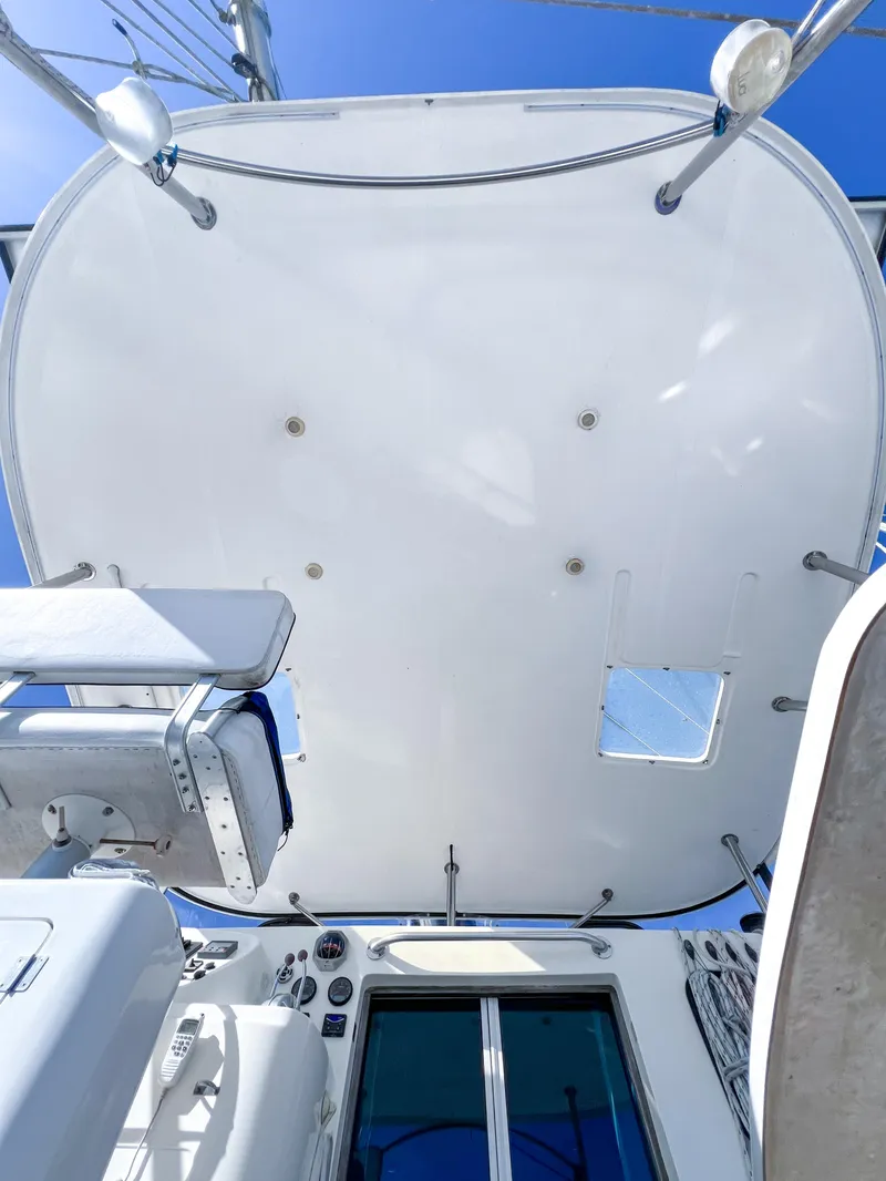 Slide: The Image of Broadblue 435 catamaran deck view, showcasing sleek design and modern features, under clear blue sky. - 37