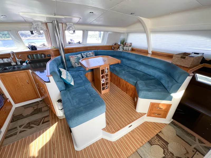 Slide: The Image of Spacious interior of 2010 Broadblue 435 catamaran with blue seating and wooden accents. - 39