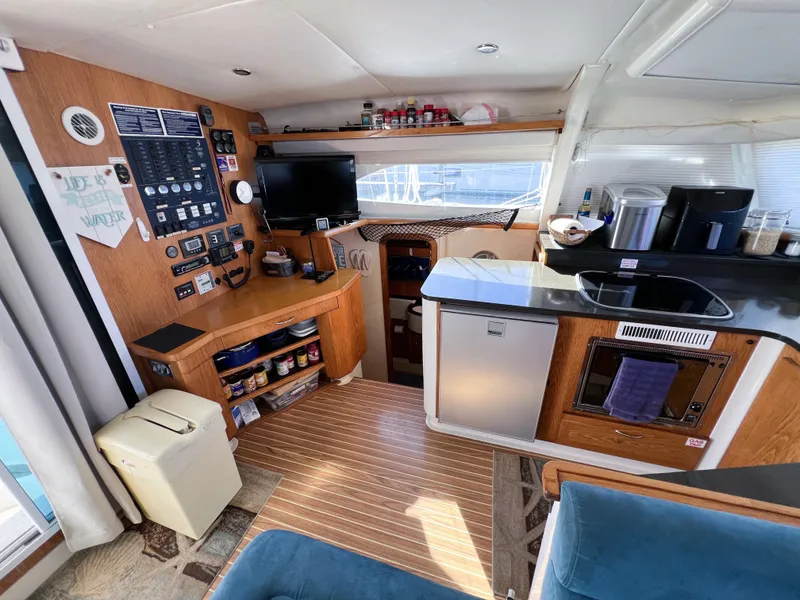 Slide: The Image of Interior of 2010 Broadblue 435 catamaran with kitchen, control panel, and seating area. - 44