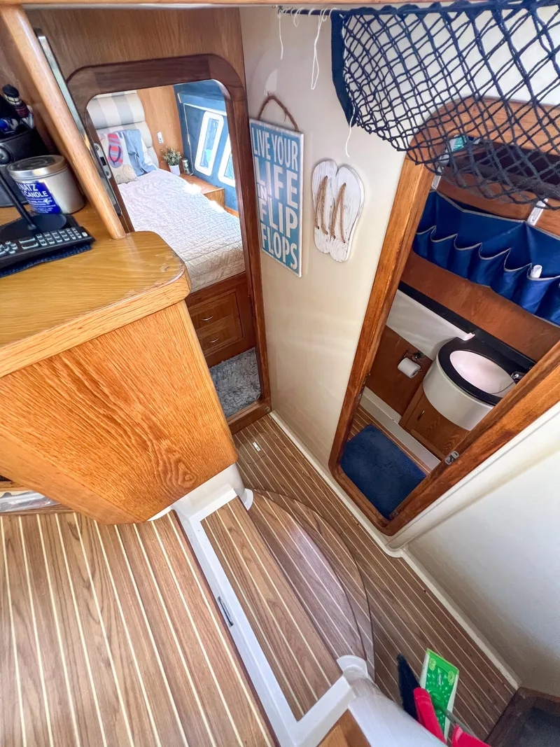 Slide: The Image of Interior of a 2010 Broadblue 435 catamaran with wood accents and nautical decor. - 48
