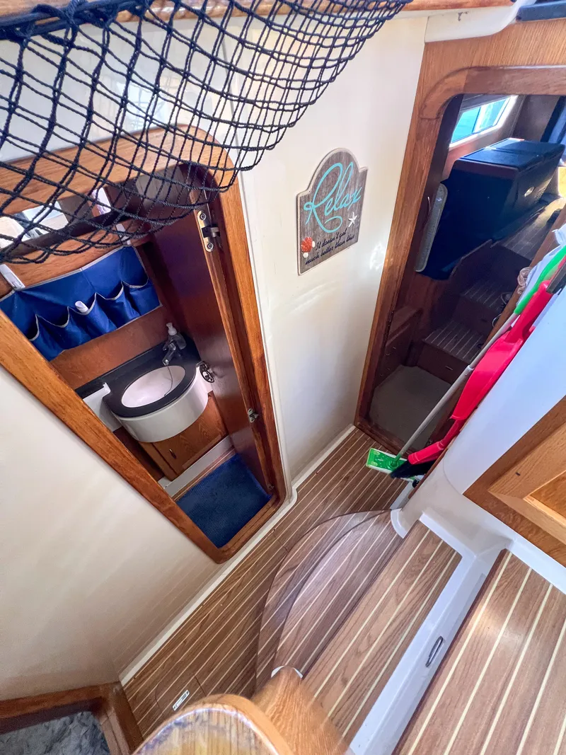 Slide: The Image of Interior of 2010 Broadblue 435 catamaran, featuring bathroom and wooden flooring. - 49