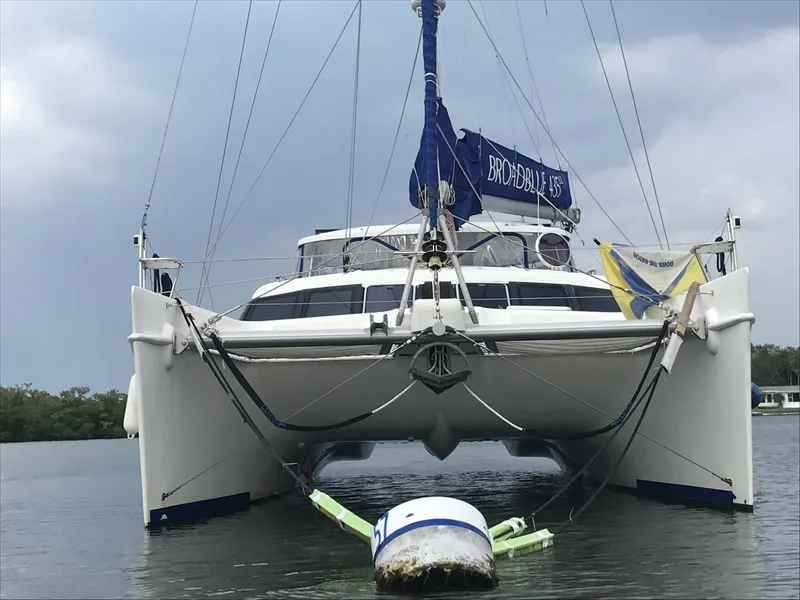 Slide: The Image of 2010 Broadblue 435 catamaran anchored on calm water under cloudy skies. - 5