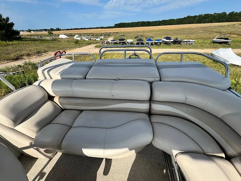 Slide: The Image of 2005 Crest 25 Savannah boat with spacious seating in a scenic outdoor setting. - 12