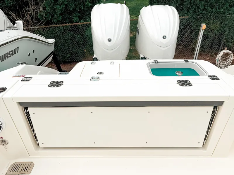 Slide: The Image of 2025 Cobia 285 Center Console boat with dual engines and fishing station. - 10