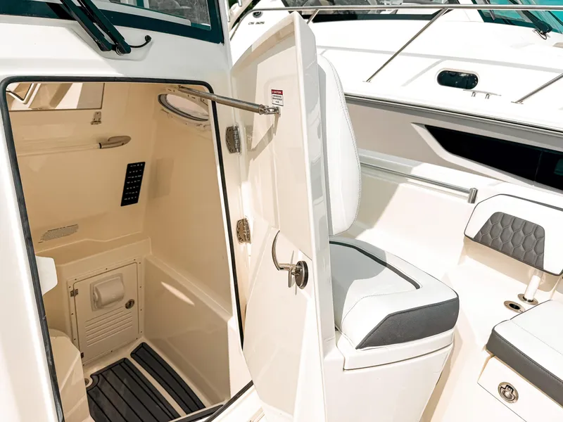 Slide: The Image of 2025 Cobia 285 Center Console boat interior with seating and storage area. - 16