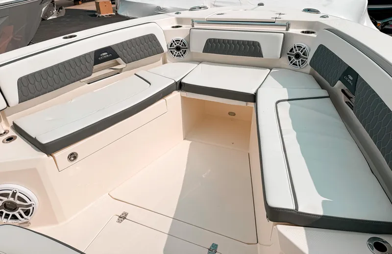 Slide: The Image of 2025 Cobia 285 Center Console boat interior with cushioned seating and built-in speakers. - 17