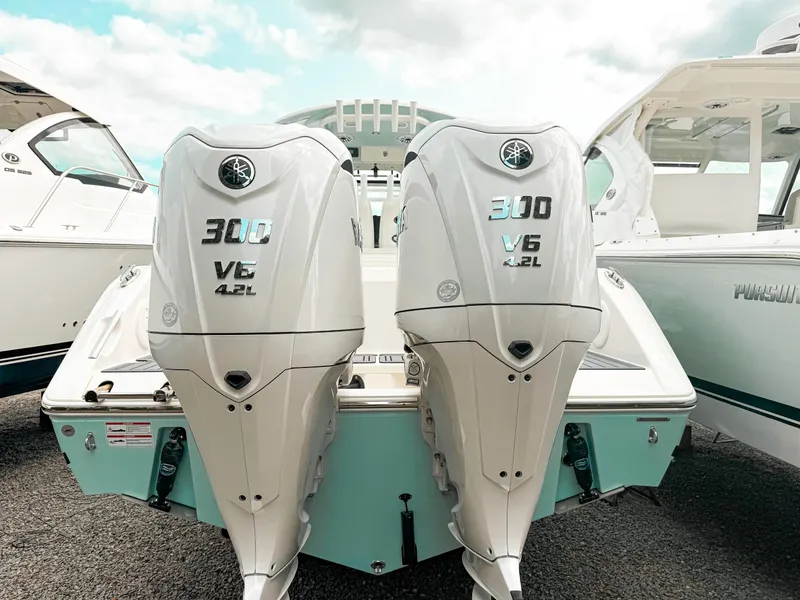 Slide: The Image of 2025 Cobia 285 Center Console with twin 300 V6 outboard engines. - 2