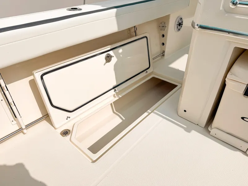 Slide: The Image of 2025 Cobia 285 Center Console boat storage compartment, open and spacious design. - 21