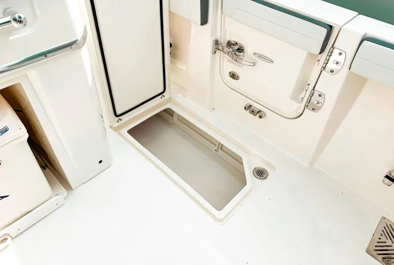 Slide: The Image of 2025 Cobia 285 Center Console boat interior with open storage compartment. - 22