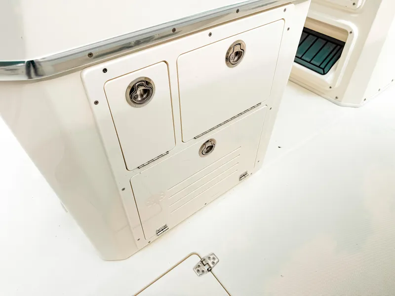 Slide: The Image of 2025 Cobia 285 Center Console storage compartments on deck. - 24