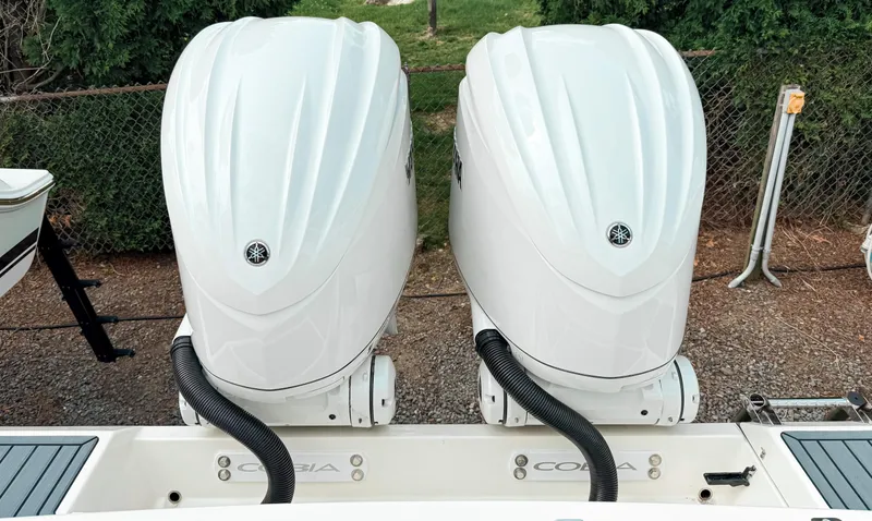Slide: The Image of 2025 Cobia 285 Center Console with dual outboard engines, rear view. - 27