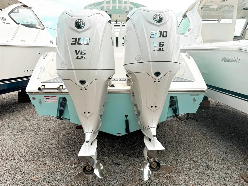 Slide: The Image of 2025 Cobia 285 Center Console with twin 300 V6 4.2L outboard engines. - 3