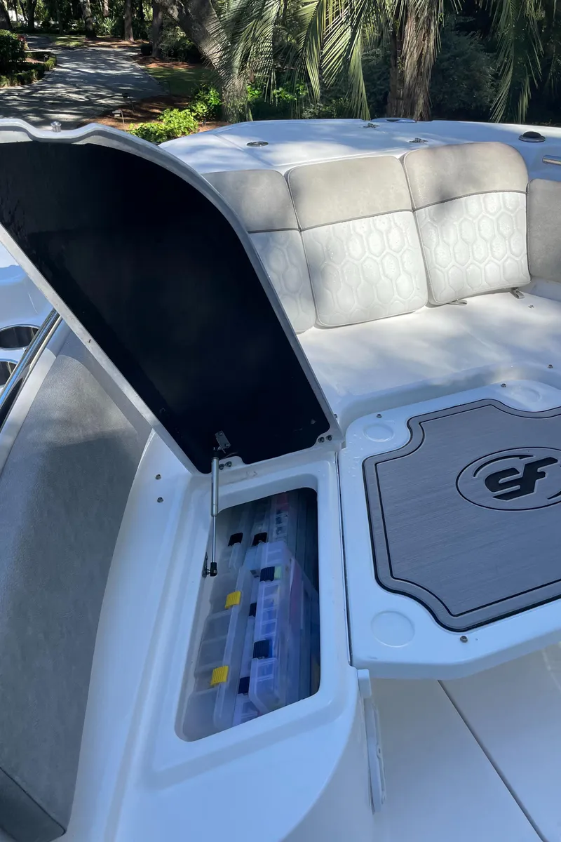 Slide: The Image of 2021 Sea Fox 288 Commander boat with open storage compartment and cushioned seating. - 10