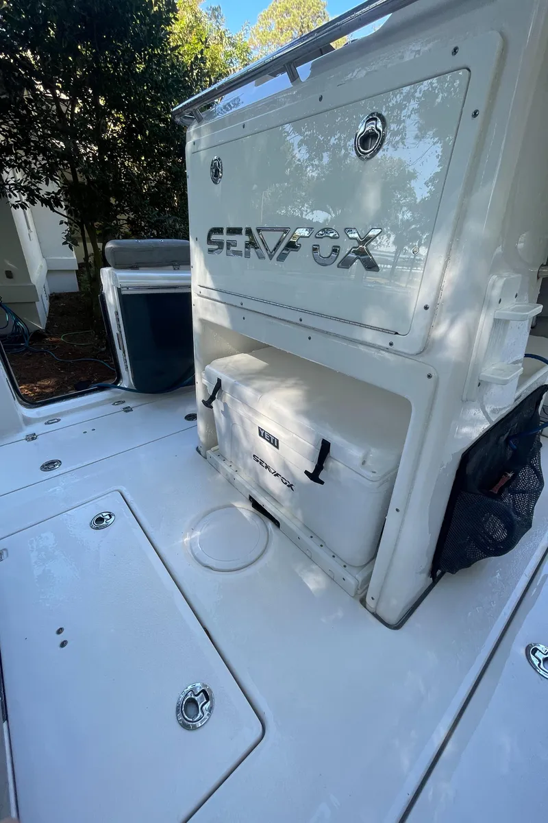 Slide: The Image of 2021 Sea Fox 288 Commander boat deck with storage compartments and cooler. - 14