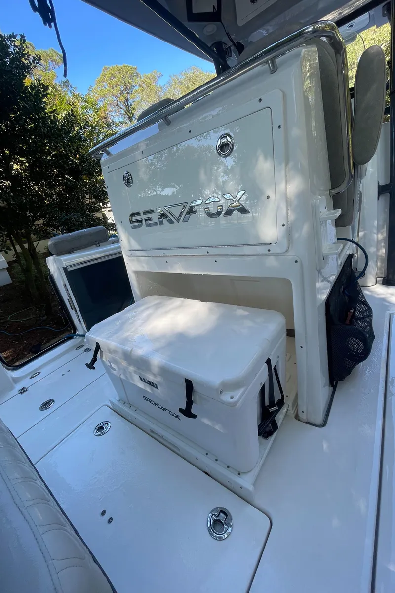 Slide: The Image of 2021 Sea Fox 288 Commander boat interior with storage and cooler. - 15
