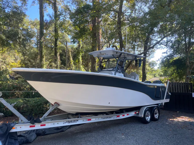 Slide: The Image of 2021 Sea Fox 288 Commander boat on trailer in wooded area. - 2