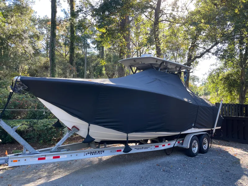 Slide: The Image of 2021 Sea Fox 288 Commander boat covered on trailer in wooded area. - 20