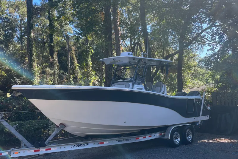 Slide: The Image of 2021 Sea Fox 288 Commander boat on trailer in wooded area. - 3