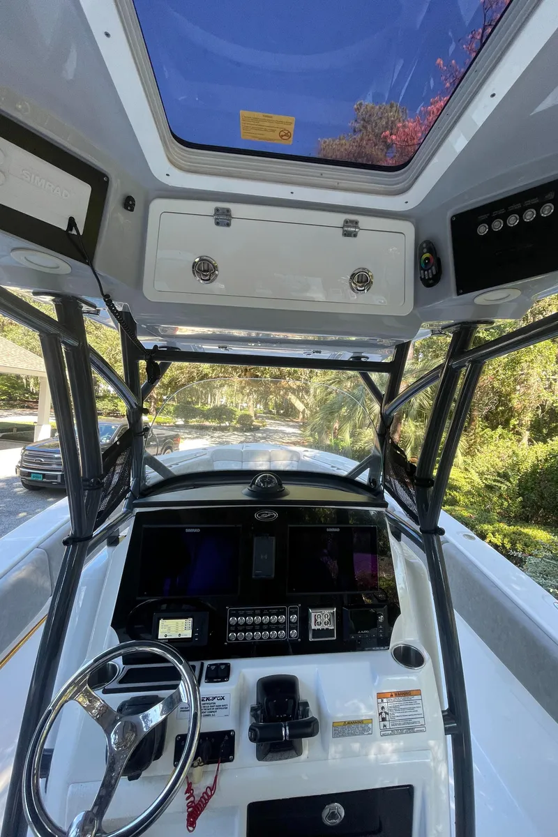 Slide: The Image of 2021 Sea Fox 288 Commander boat cockpit with steering wheel and control panel. - 4