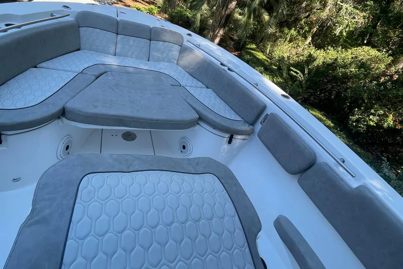 Slide: The Image of 2021 Sea Fox 288 Commander boat interior with cushioned seating and hexagonal pattern design. - 9
