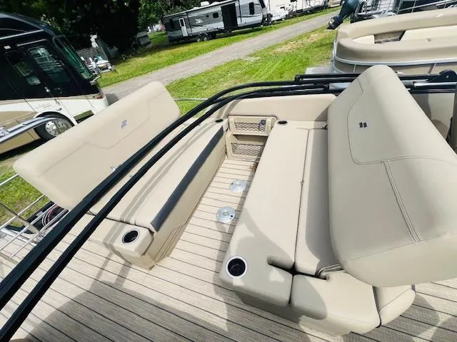 Slide: The Image of 2023 Starcraft CX 23 DL pontoon boat with beige seating and cup holders. - 4