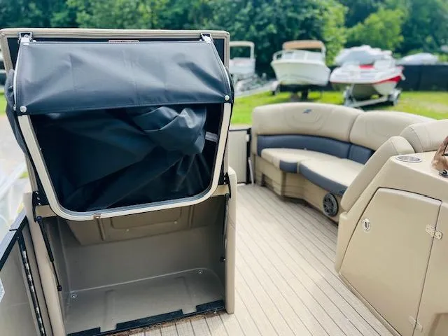 Slide: The Image of 2023 Starcraft CX 23 DL pontoon boat interior with seating and storage. - 5