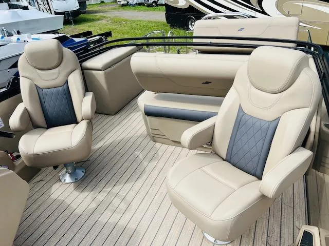 Slide: The Image of 2023 Starcraft CX 23 DL boat interior with beige and gray seating. - 6
