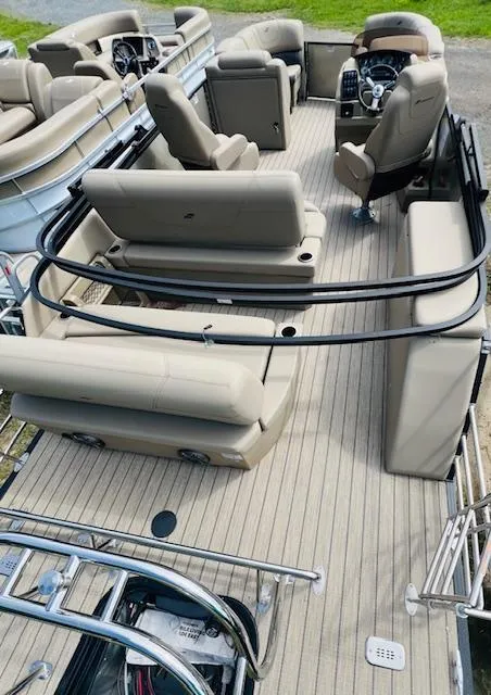 Slide: The Image of 2023 Starcraft CX 23 DL boat interior with beige seating and modern controls. - 8