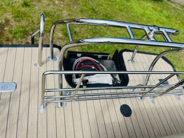 Slide: The Image of Starcraft CX 23 DL 2023 boat deck with railing and storage compartment. - 9