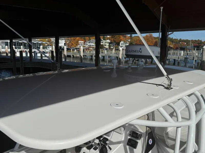 Slide: The Image of 2011 Intrepid 370 Cuddy boat docked, featuring Garmin equipment, with autumn trees in the background. - 11