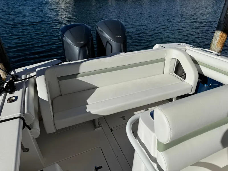 Slide: The Image of 2011 Intrepid 370 Cuddy boat interior with seating and twin engines. - 12