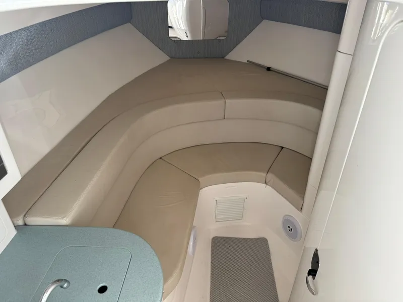 Slide: The Image of 2011 Intrepid 370 Cuddy interior with beige seating and compact design. - 13