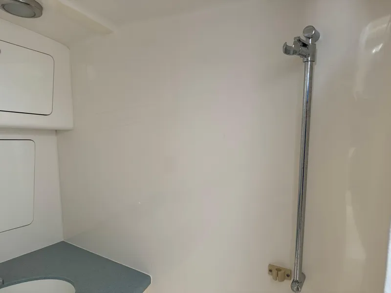 Slide: The Image of Interior of 2011 Intrepid 370 Cuddy boat, featuring a compact bathroom area. - 16