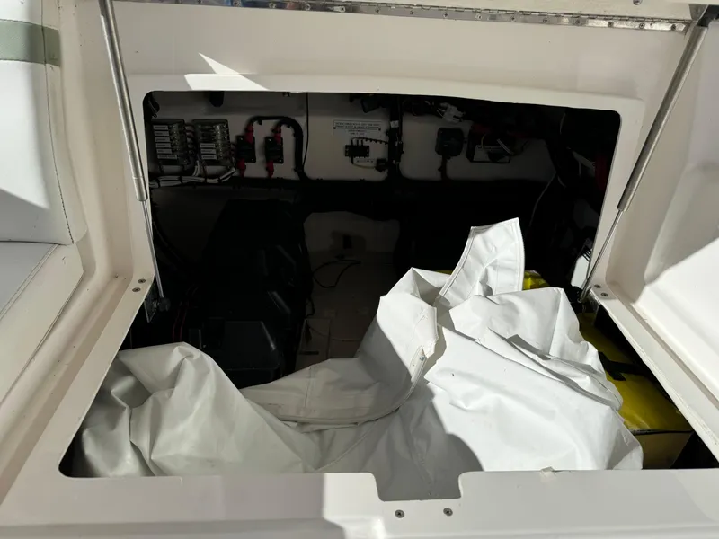 Slide: The Image of 2011 Intrepid 370 Cuddy interior with storage compartment and electrical panel. - 17