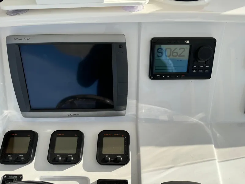 Slide: The Image of Intrepid 370 Cuddy 2011 dashboard with Garmin navigation and control displays. - 22