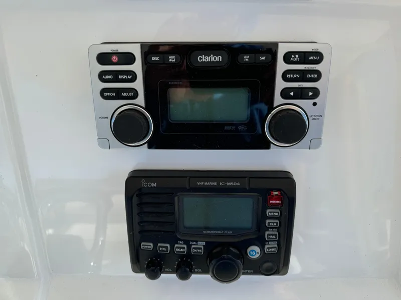 Slide: The Image of Clarion and Icom marine radios on 2011 Intrepid 370 Cuddy boat dashboard. - 23