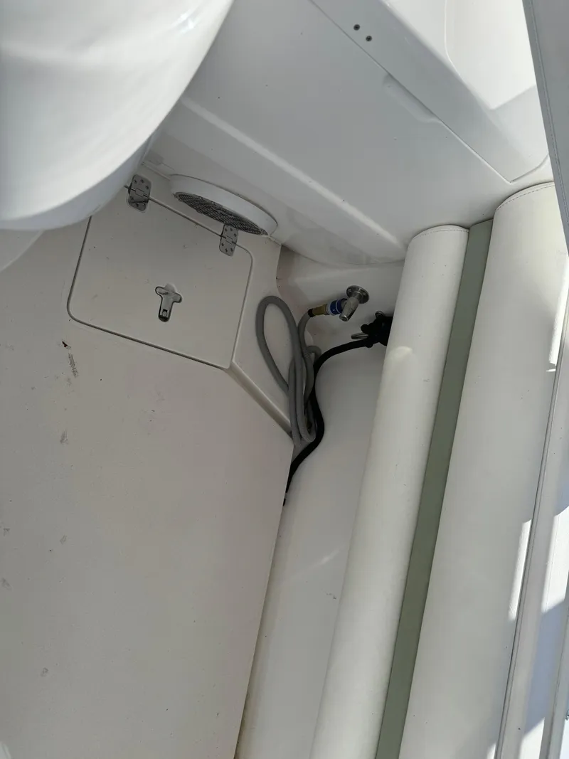 Slide: The Image of Interior view of 2011 Intrepid 370 Cuddy boat, featuring storage compartment and seating area. - 25