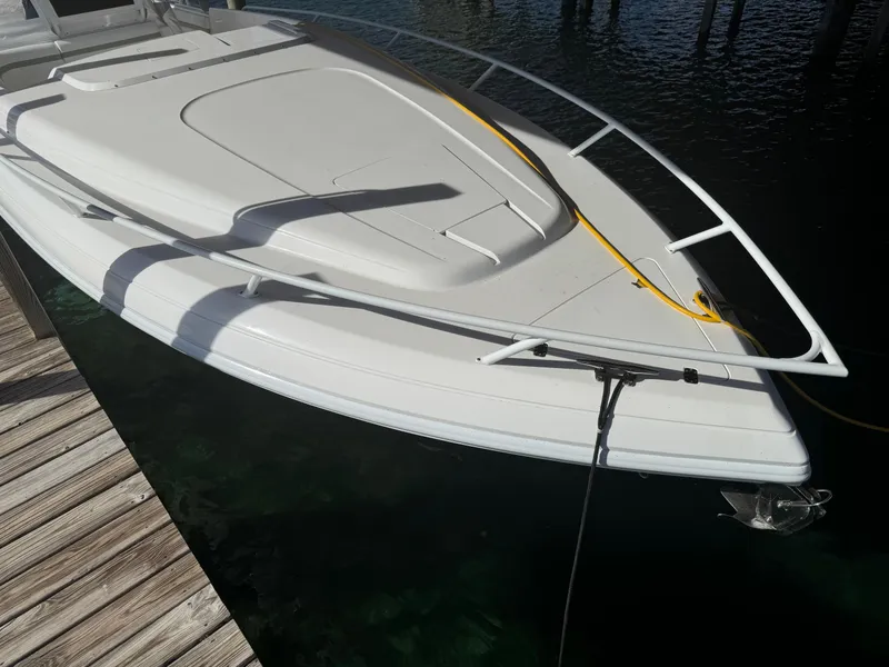 Slide: The Image of 2011 Intrepid 370 Cuddy boat docked, showcasing sleek design and spacious deck. - 4