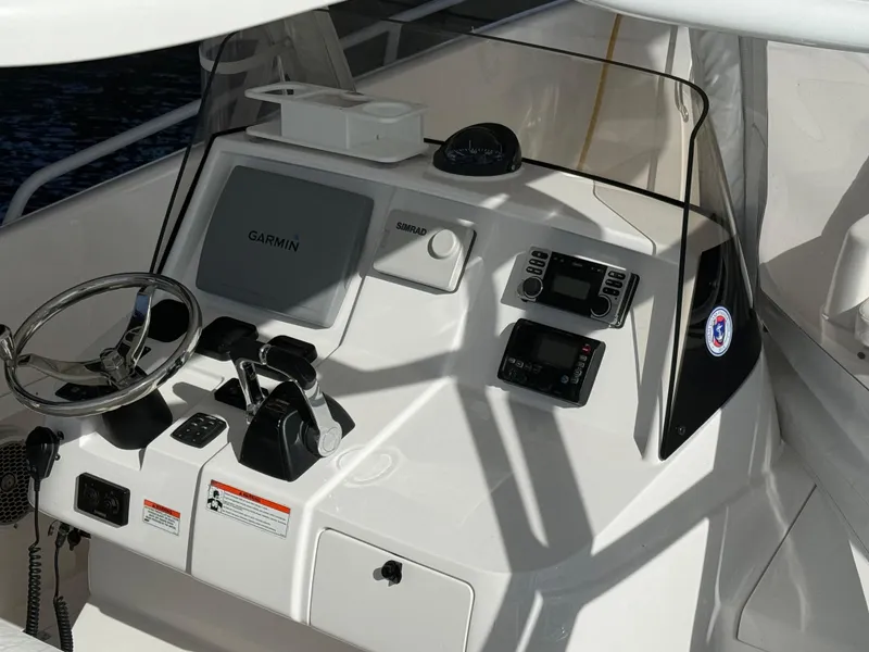 Slide: The Image of 2011 Intrepid 370 Cuddy helm with Garmin navigation system and controls. - 9
